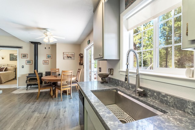 12637 Ivie Ln, Old Station, CA 96071 - kitchen with a sink, light wood-type flooring, ceiling fan, a wood stove, and dishwasher