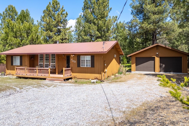 12637 Ivie Ln, Old Station, CA 96071 - view of front of property with a garage, metal roof, an outbuilding, and a porch