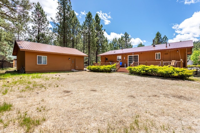 12637 Ivie Ln, Old Station, CA 96071 - rear view of house featuring metal roof, a wooden deck, and board and batten siding