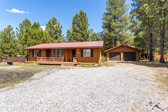 12637 Ivie Ln, Old Station, CA 96071 - view of front of property with a porch, a garage, board and batten siding, an outbuilding, and metal roof