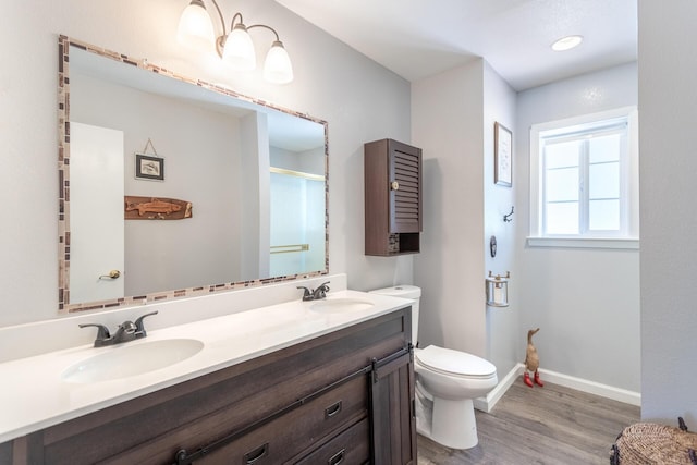 12637 Ivie Ln, Old Station, CA 96071 - full bath with wood finished floors, a shower stall, toilet, double vanity, and baseboards