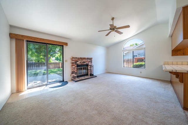 2529 Candlewood Dr, Redding, CA 96003 - unfurnished living room featuring healthy amount of natural light, lofted ceiling, ceiling fan, a brick fireplace, and light carpet