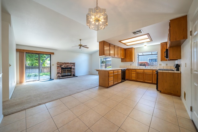 2529 Candlewood Dr, Redding, CA 96003 - kitchen featuring light carpet, gas stove, black dishwasher, light countertops, and brown cabinets
