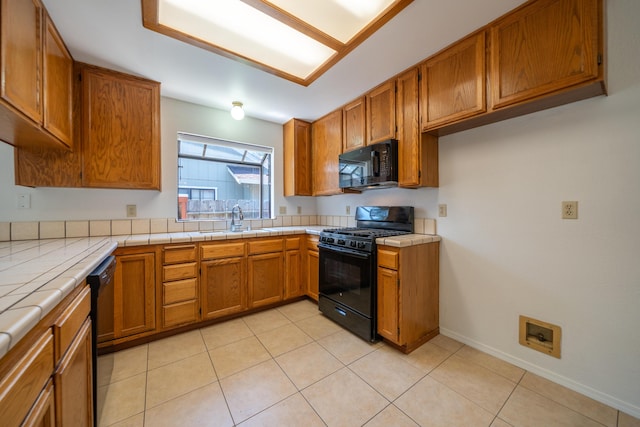 2529 Candlewood Dr, Redding, CA 96003 - kitchen featuring black appliances, brown cabinets, tile counters, and light tile patterned floors