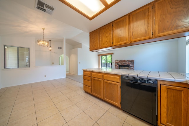 2529 Candlewood Dr, Redding, CA 96003 - kitchen with dishwasher, tile counters, vaulted ceiling, brown cabinets, and a chandelier