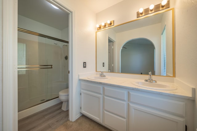 2529 Candlewood Dr, Redding, CA 96003 - bathroom with an enclosed shower, double vanity, and wood finished floors