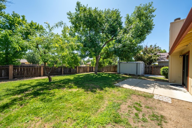 2529 Candlewood Dr, Redding, CA 96003 - fenced backyard featuring a storage unit and a patio area
