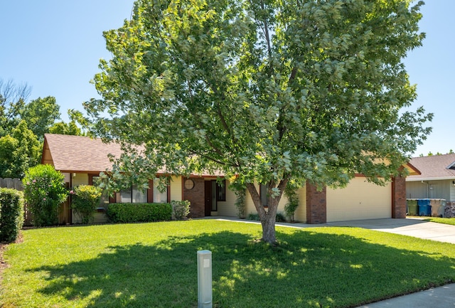 2529 Candlewood Dr, Redding, CA 96003 - obstructed view of property with brick siding, concrete driveway, a front yard, a shingled roof, and an attached garage