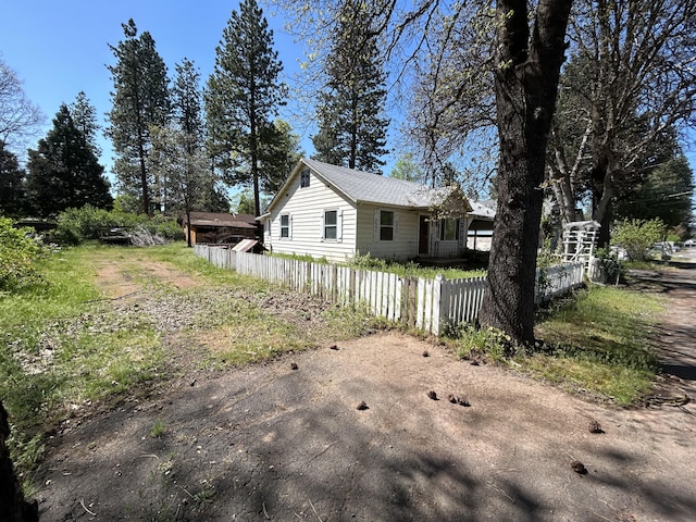 view of side of property featuring fence