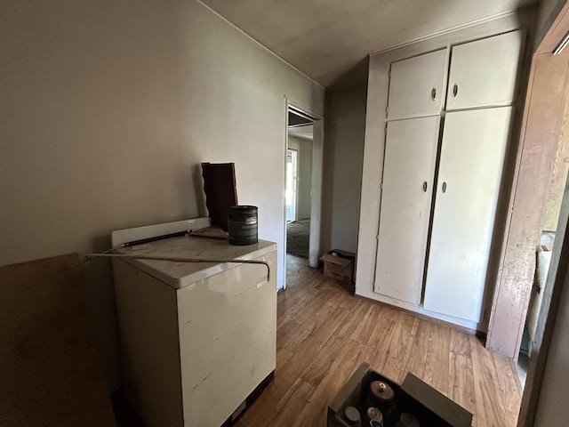 interior space featuring laundry area and wood finished floors