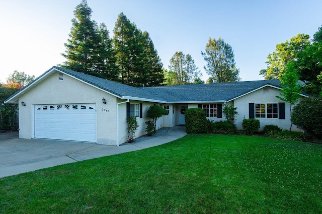 ranch-style home with a garage, concrete driveway, a front yard, and stucco siding
