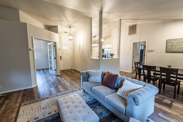 living room with lofted ceiling, wood finished floors, and baseboards
