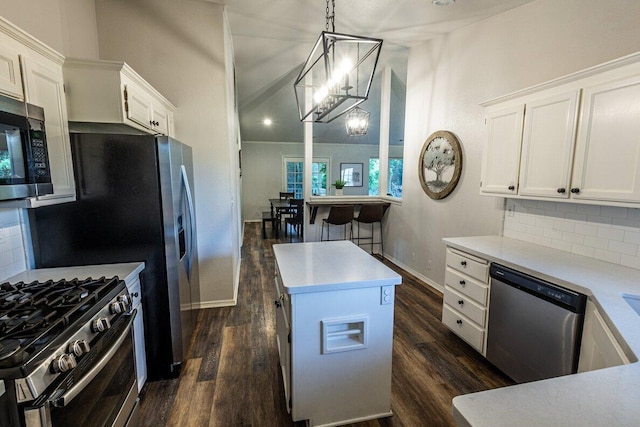 kitchen featuring stainless steel appliances, backsplash, dark wood-style flooring, and vaulted ceiling