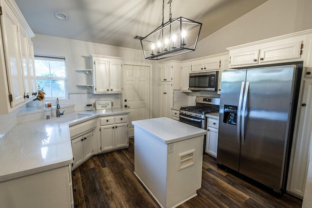 kitchen featuring appliances with stainless steel finishes, tasteful backsplash, a sink, white cabinetry, and recessed lighting