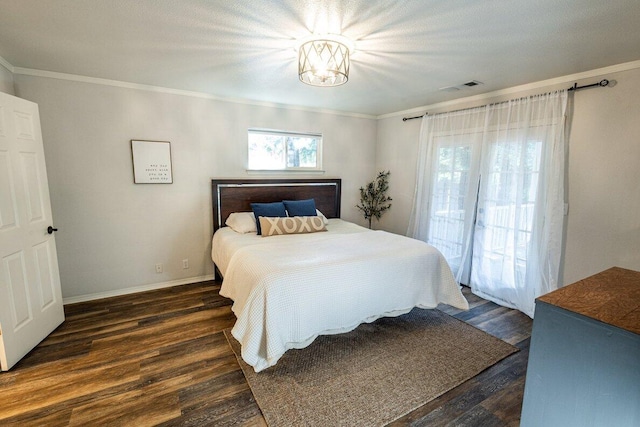 bedroom with dark wood-type flooring, a chandelier, ornamental molding, and baseboards