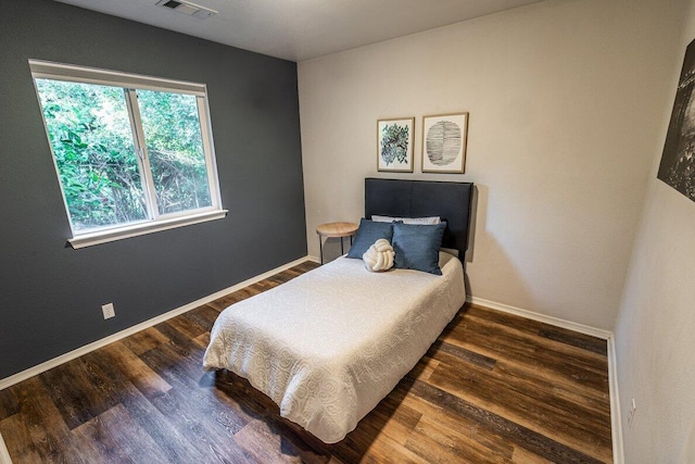 bedroom featuring wood finished floors and baseboards