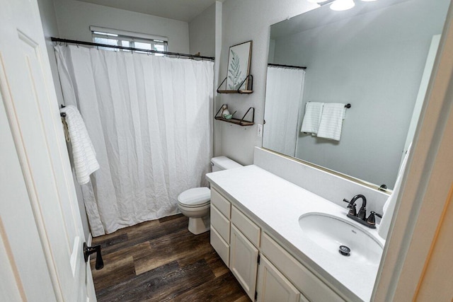 bathroom featuring wood finished floors, toilet, vanity, and a shower with curtain