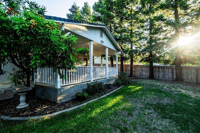view of yard featuring covered porch