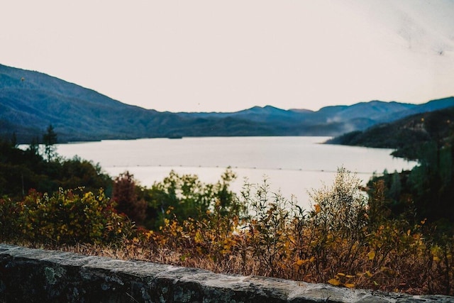 view of mountain backdrop with a nearby body of water