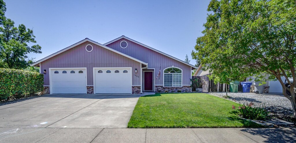 single story home featuring an attached garage and concrete driveway