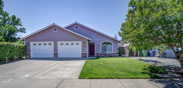 single story home featuring an attached garage and concrete driveway