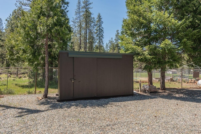 view of shed with fence