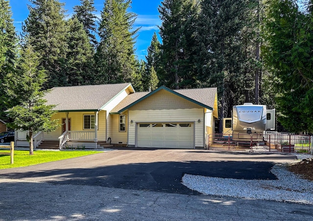 35363 Nehemiah Dr, Shingletown, CA 96088 - ranch-style home featuring a garage, driveway, covered porch, and roof with shingles
