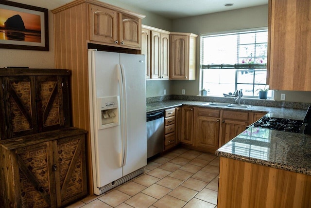 35363 Nehemiah Dr, Shingletown, CA 96088 - kitchen with stainless steel dishwasher, white fridge with ice dispenser, a sink, light tile patterned floors, and dark stone counters