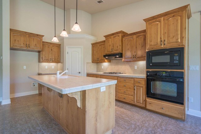 3641 Deuce Way, Redding, CA 96002 - kitchen featuring black appliances, a sink, under cabinet range hood, a high ceiling, and tile countertops
