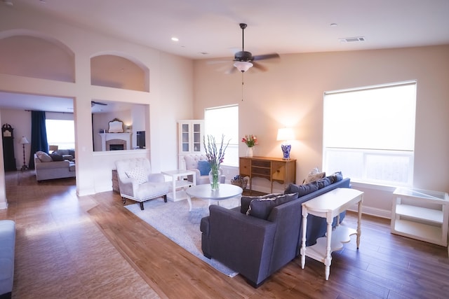 3641 Deuce Way, Redding, CA 96002 - living room with wood finished floors, a fireplace, and a ceiling fan