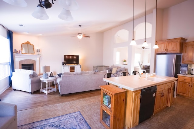 3641 Deuce Way, Redding, CA 96002 - kitchen with dishwasher, a sink, open floor plan, a ceiling fan, and tile counters