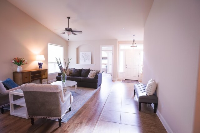 3641 Deuce Way, Redding, CA 96002 - living room featuring ceiling fan, baseboards, wood finished floors, and vaulted ceiling