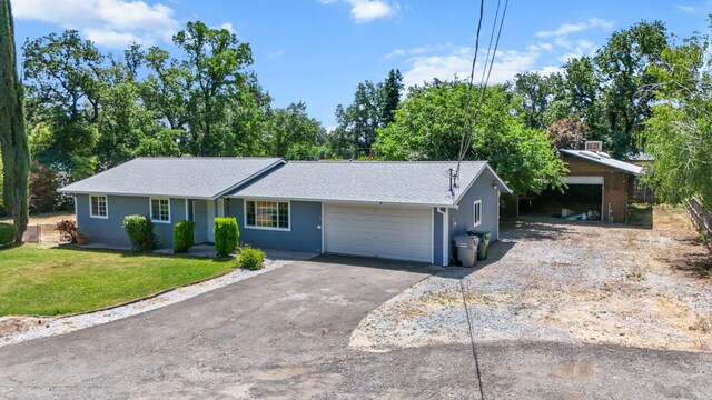 19017 Snowflake Ln, Redding, CA 96003 - single story home featuring a garage, driveway, a front yard, stucco siding, and a shingled roof