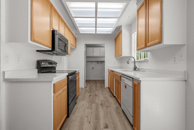 19017 Snowflake Ln, Redding, CA 96003 - kitchen with black range with electric stovetop, a sink, dishwasher, light wood-style floors, and stainless steel microwave