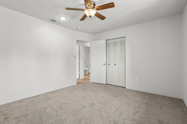 19017 Snowflake Ln, Redding, CA 96003 - unfurnished bedroom with carpet flooring, a closet, a textured ceiling, and ceiling fan