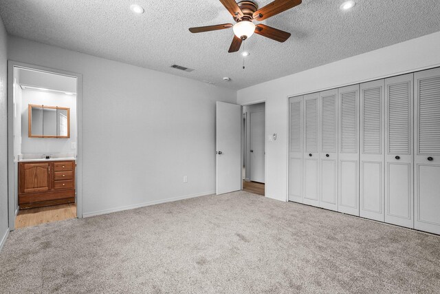 19017 Snowflake Ln, Redding, CA 96003 - unfurnished bedroom featuring light colored carpet, a textured ceiling, a closet, baseboards, and ensuite bath