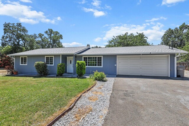 19017 Snowflake Ln, Redding, CA 96003 - single story home featuring asphalt driveway, a garage, and a front yard