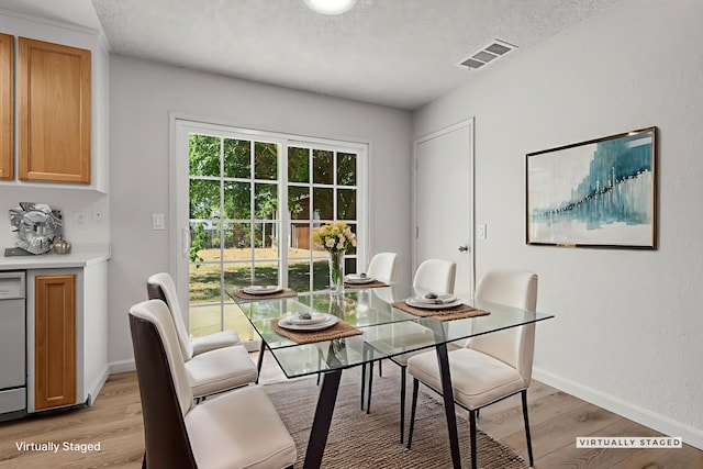 19017 Snowflake Ln, Redding, CA 96003 - dining room with light wood finished floors, baseboards, and a textured ceiling