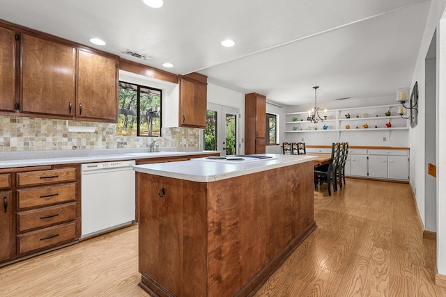 21030 Shangrila Dr, Red Bluff, CA 96080 - kitchen featuring white appliances, light wood-style floors, a sink, a center island, and light countertops