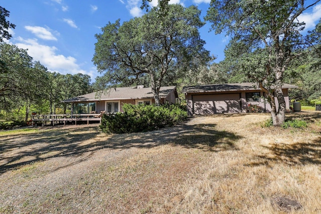 21030 Shangrila Dr, Red Bluff, CA 96080 - view of front of home featuring dirt driveway, a deck, and a garage