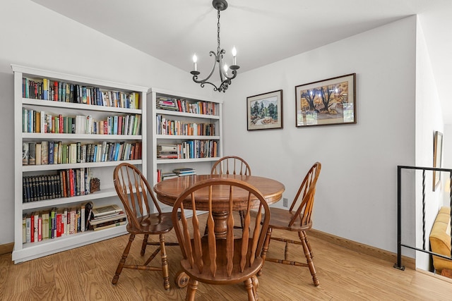 21030 Shangrila Dr, Red Bluff, CA 96080 - dining room with a chandelier, baseboards, and wood finished floors