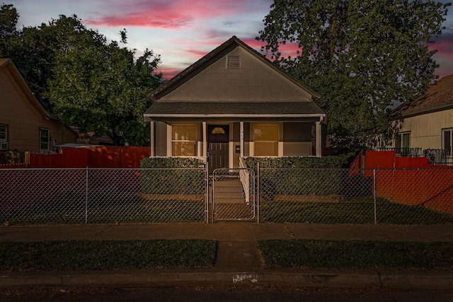 1048 Franklin St, Red Bluff, CA 96080 - bungalow with covered porch, a fenced front yard, a gate, and a shingled roof