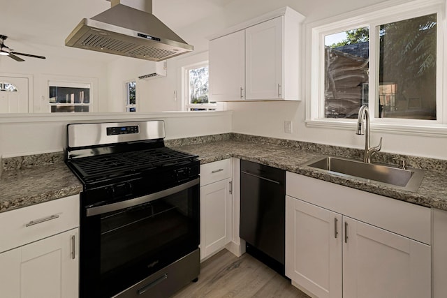 1048 Franklin St, Red Bluff, CA 96080 - kitchen featuring a sink, stainless steel gas stove, dishwasher, wall chimney exhaust hood, and light wood-style floors