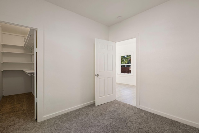 1048 Franklin St, Red Bluff, CA 96080 - unfurnished bedroom with carpet flooring, a closet, baseboards, and a walk in closet