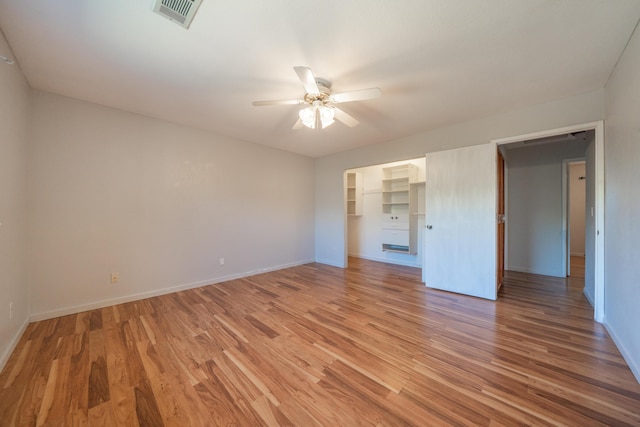 unfurnished bedroom with light wood-type flooring, baseboards, a ceiling fan, and a closet
