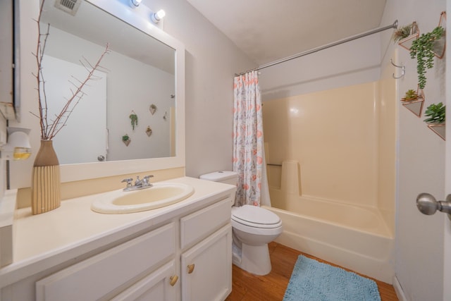 full bathroom featuring toilet, wood finished floors, vanity, and shower / bathtub combination with curtain