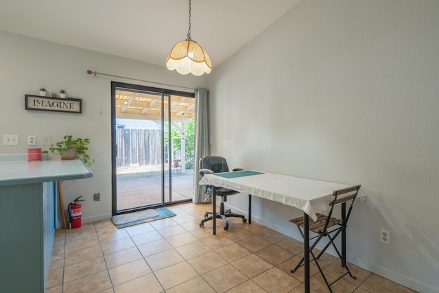 office featuring baseboards, vaulted ceiling, and light tile patterned floors