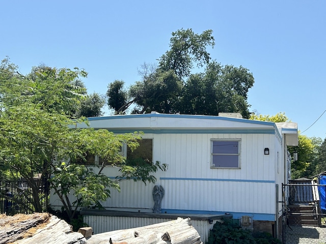 view of home's exterior with fence