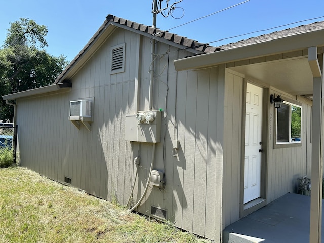 view of side of property featuring an AC wall unit