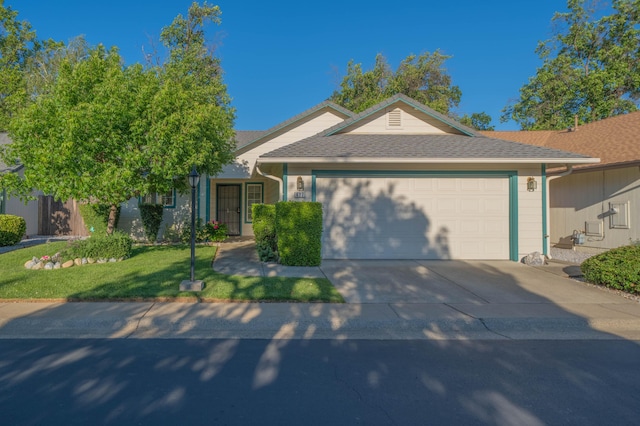 ranch-style home with an attached garage, driveway, a front yard, and a shingled roof
